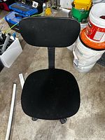 Full view of black armless swivel chair from above