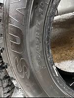 Sidewall showing size 225/65R17 and part of brand lettering
