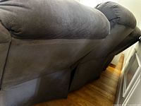 Rear view of microfiber reclining sofa showing back cushions and upholstery