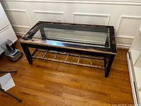 Full view of rectangular rustic wood coffee table with glass top