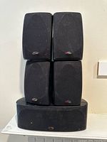 Front view showing five Polk Audio speakers stacked
