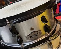 TRAK snare drum silver shell, black hoops and lugs