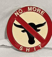 Front view of round belt buckle showing full design and text