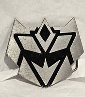 front view of silver and black Decepticon logo belt buckle