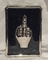 front view of belt buckle showing hand motif and rhinestones