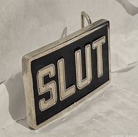 oblique view of buckle front showing lettering and finish