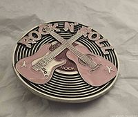 Front view showing full design with crossed guitars and lettering