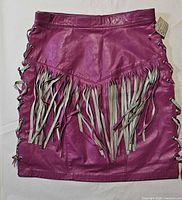Full view of hot pink leather skirt showing fringe and side lace-up