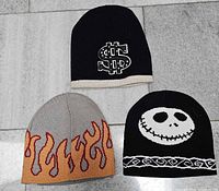 Front view of all three beanies displaying graphics and colors