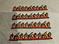Four flame patches shown front, embroidery detail visible