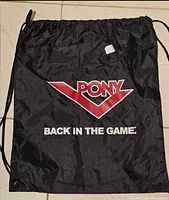 Front view of black Pony drawstring backpack showing logo, slogan, straps, and eyelets
