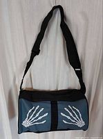 Front view shows skeleton hand graphics and overall colour scheme