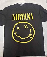 Front view showing Nirvana text and smiley face logo