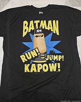 Front view of black Batman graphic T-shirt showing full design and condition