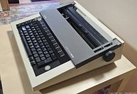Angled view of Brother electric typewriter showing keyboard and housing