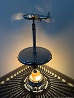 Full view of chrome airplane lamp illuminated