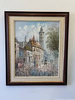 Framed Paris street scene oil painting on wall