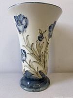 Front view showing flared trumpet form and tube-lined blue poppy decoration