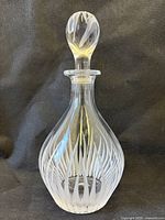 Full view of crystal decanter with stopper