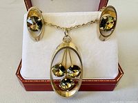 Front view of necklace and earrings set inside box