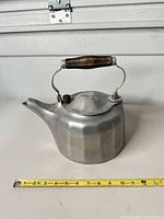 Full view of cast aluminum Griswold tea kettle with wood handle