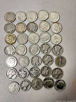 Full overhead view showing entire assortment of silver dimes laid out in rows
