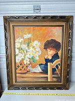 Frontal view of framed oil painting showing child and daisies