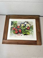 Full view of framed watercolor painting showing strawberries and wooden frame