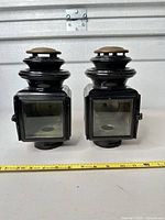 Front view of both carriage lamps showing glass panels and overall design