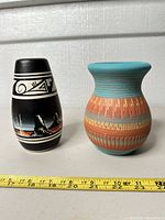 Front view of both vases beside ruler