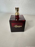 Front view of square deep red Lauren Ralph Lauren perfume bottle with atomizer