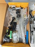 Box containing multiple hubs, spokes, grease tube, loose parts