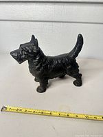 Left side view showing full profile and tape measure for scale