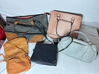 Group shot of all five handbags