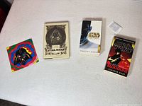 All five items laid out—three books, canvas, card case