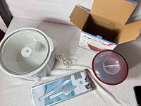 Group shot of slow cooker, popcorn popper with box, cake server set