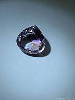 Front view of faceted pear-cut ametrine showing colour zoning