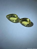 Both lemon citrine gemstones side by side on neutral background