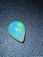 Front view of pear opal showing play-of-color greens and blues