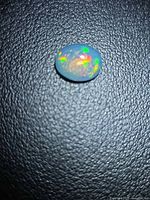 Top view of oval opal cabochon showing play of color