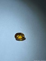 Front view of the oval Mandarin orange sapphire