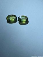 Pair of oval tricolored sapphires front view