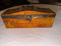 Front view showing latch, graphics, metal trim