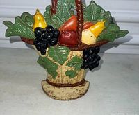 Front view of painted cast iron fruit basket door stop