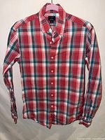 Full front view of plaid long-sleeve shirt hanging