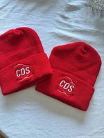 Both red CDS embroidered beanies side by side