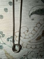 Close-up of knot pendant and chain texture