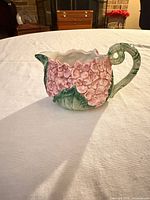 Side view showing hydrangea relief design and handle