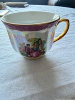 Side view showing romantic scene, purple band, gold handle