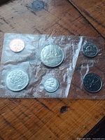 Coins reverse designs visible in sealed plastic